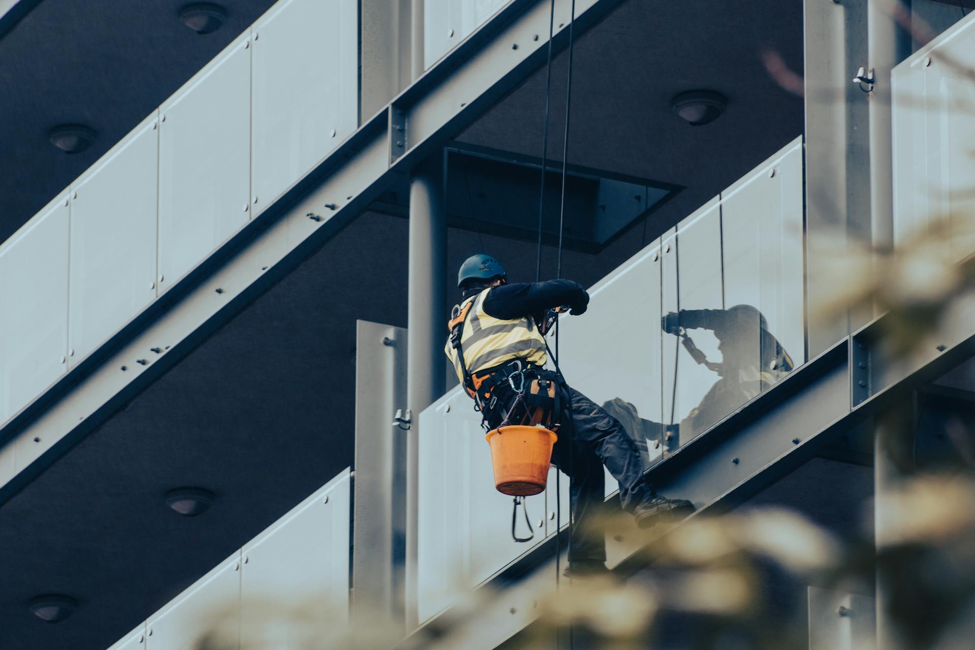 A man cleaning commercial building windows
